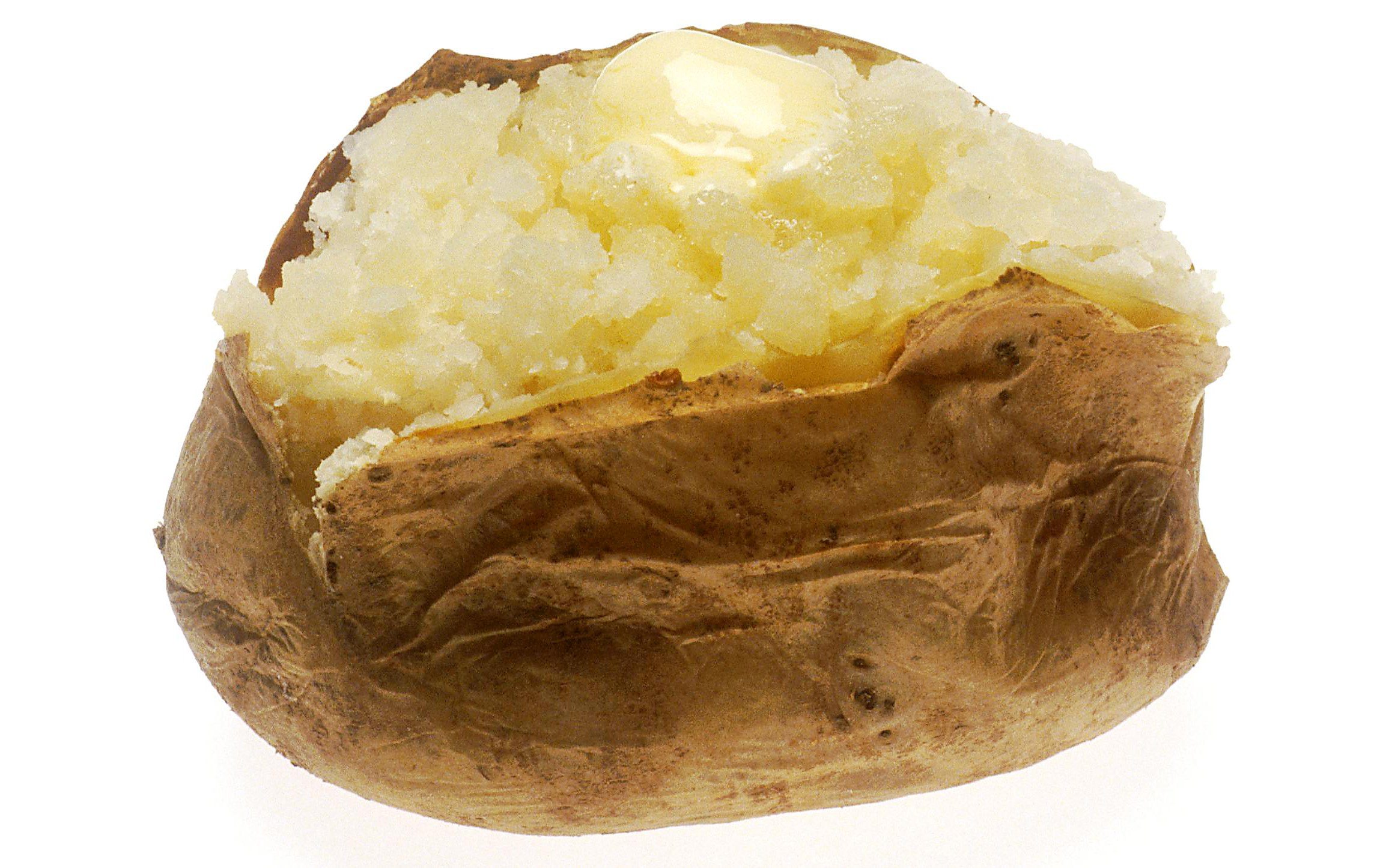 A baked potato split open with a pat of melting butter on a white background