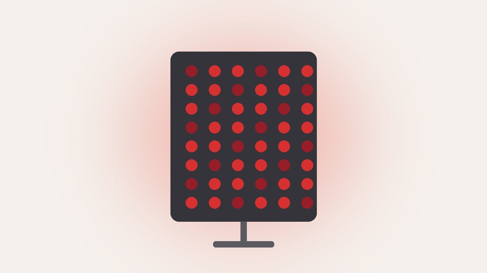 An LED light therapy panel on a stand, its red lights glowing against a pale background