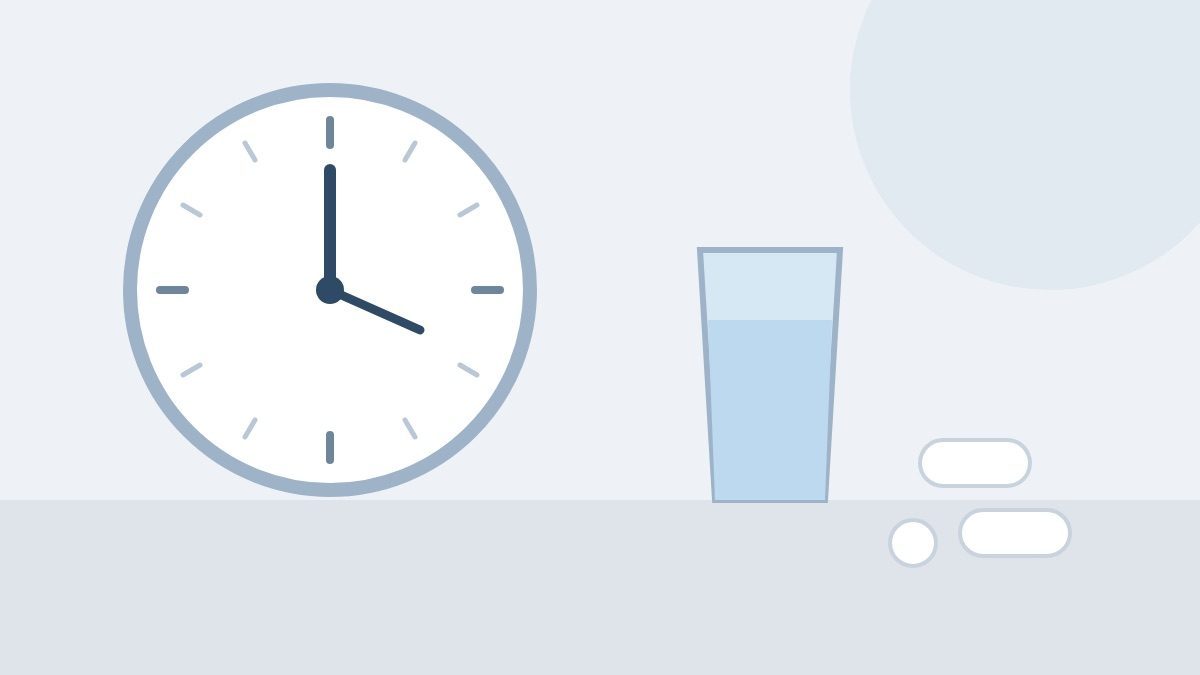 A plain wall clock, a glass of water and three unmarked white tablets on a table